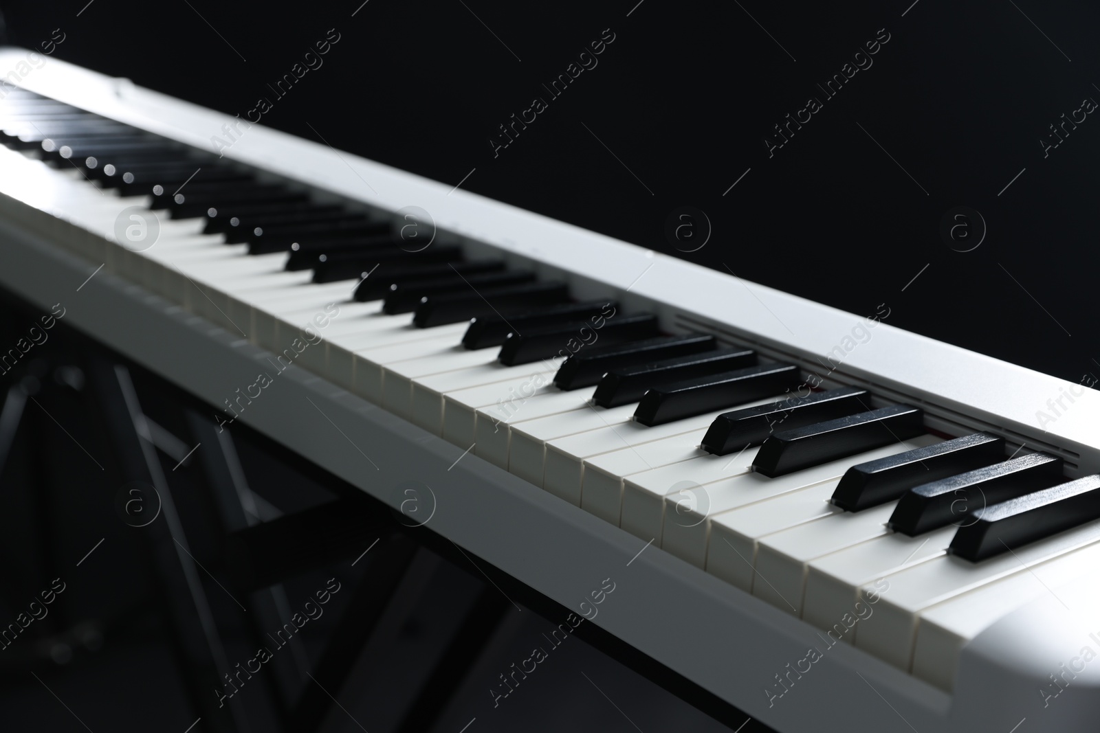 Photo of Synthesizer on black background, closeup. Electronic musical instrument