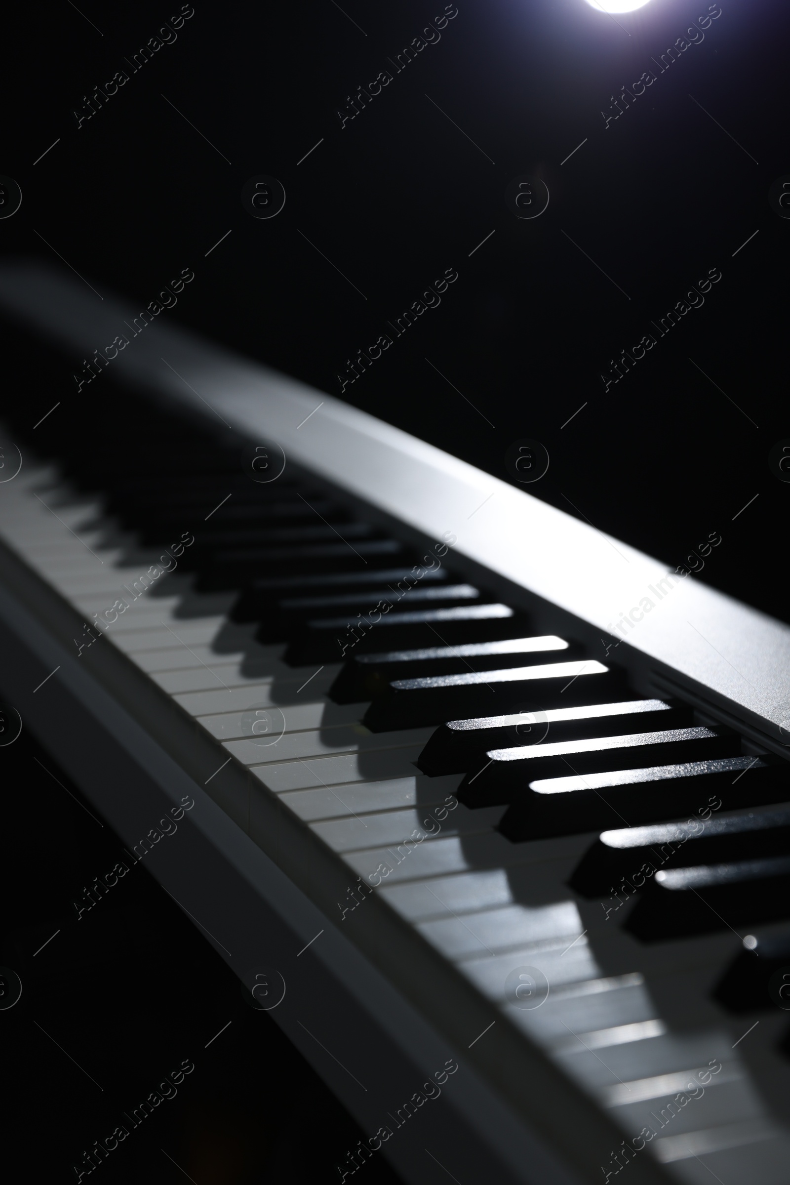 Photo of Synthesizer on black background, closeup. Electronic musical instrument