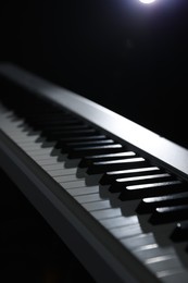 Photo of Synthesizer on black background, closeup. Electronic musical instrument