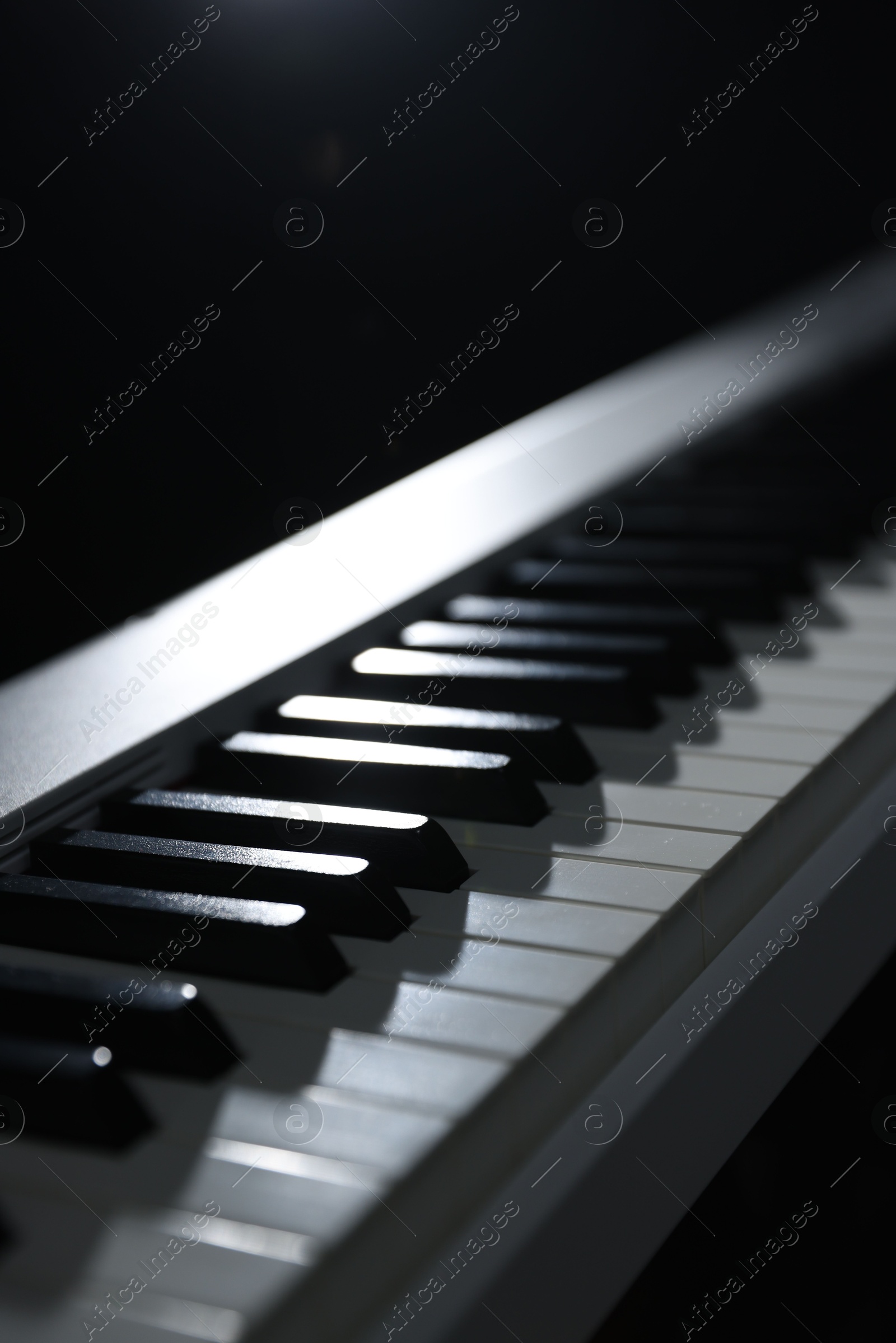 Photo of Synthesizer on black background, closeup. Electronic musical instrument