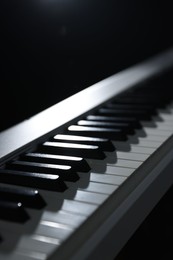 Photo of Synthesizer on black background, closeup. Electronic musical instrument