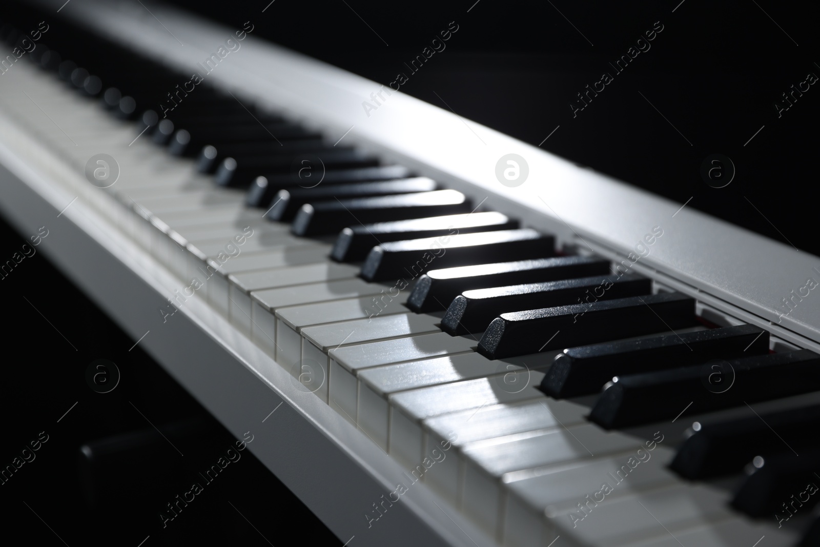 Photo of Synthesizer on black background, closeup. Electronic musical instrument