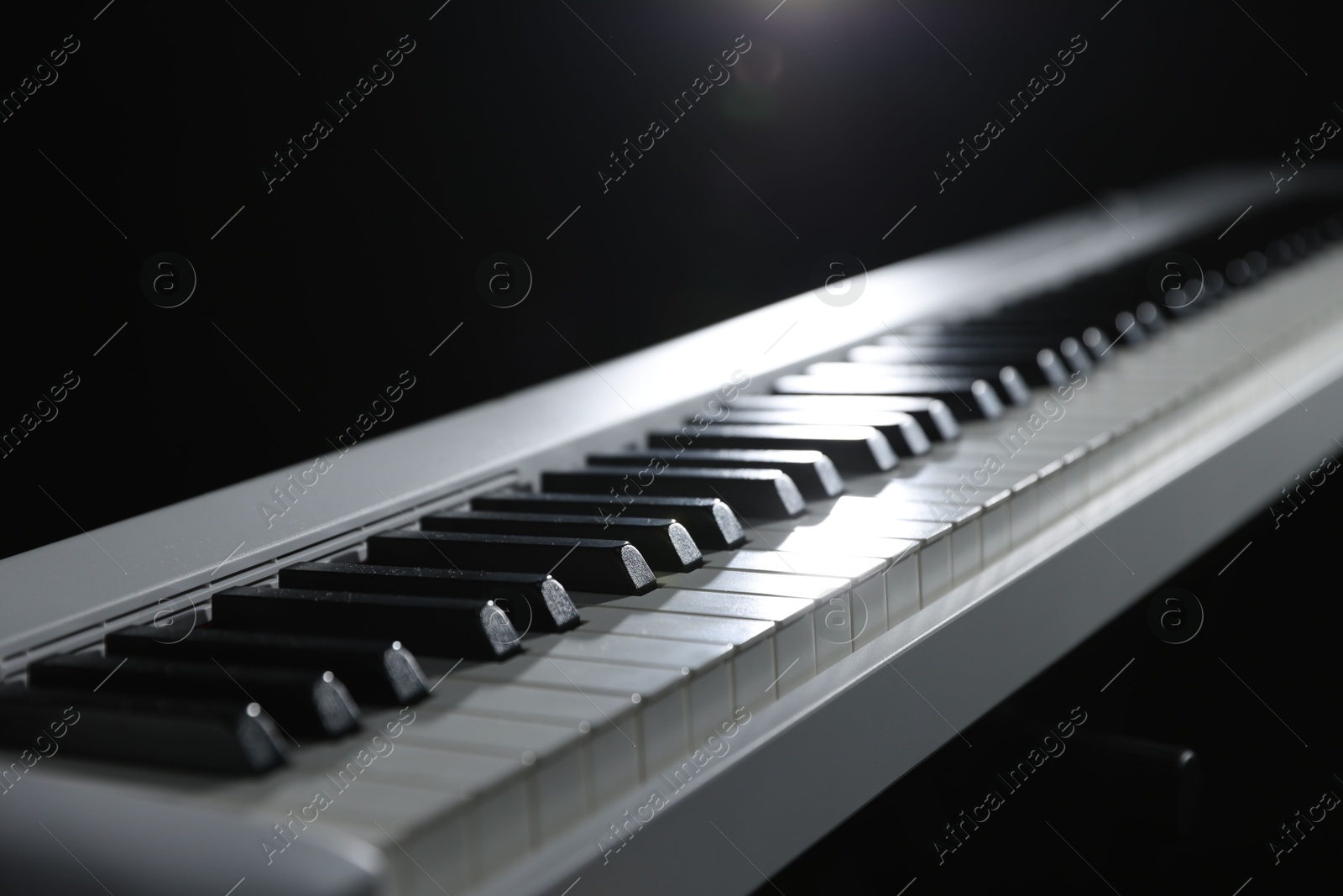 Photo of Synthesizer on black background, closeup. Electronic musical instrument