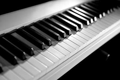 Photo of Synthesizer on black background, closeup. Electronic musical instrument