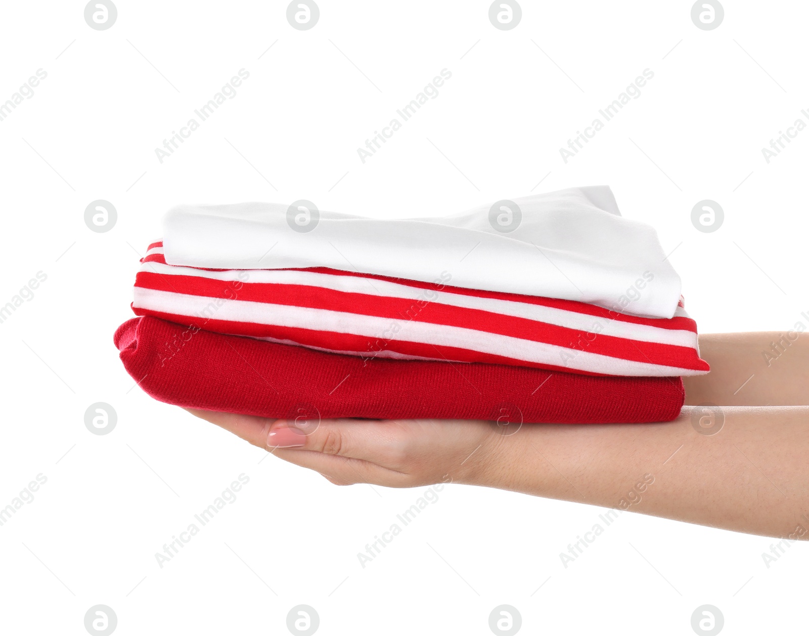 Photo of Woman holding stack of clothes on white background, closeup