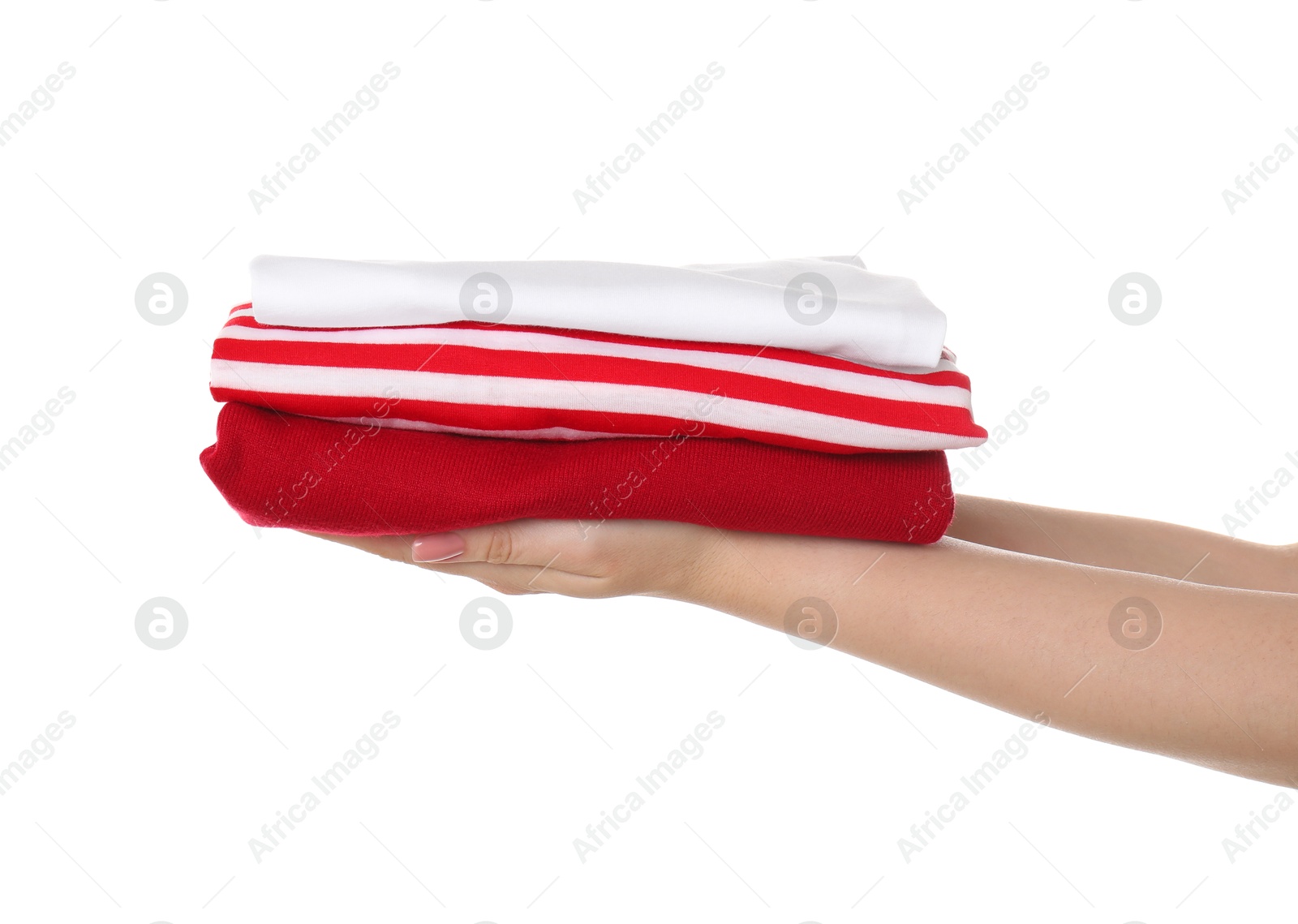 Photo of Woman holding stack of clothes on white background, closeup