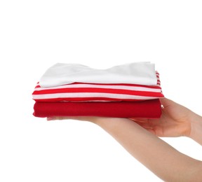 Photo of Woman holding stack of clothes on white background, closeup