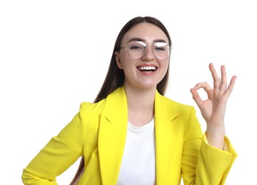 Photo of Happy young woman showing OK gesture on white background