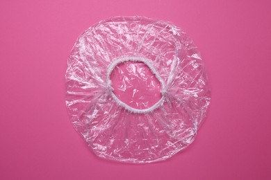 Photo of One shower cap on pink background, top view