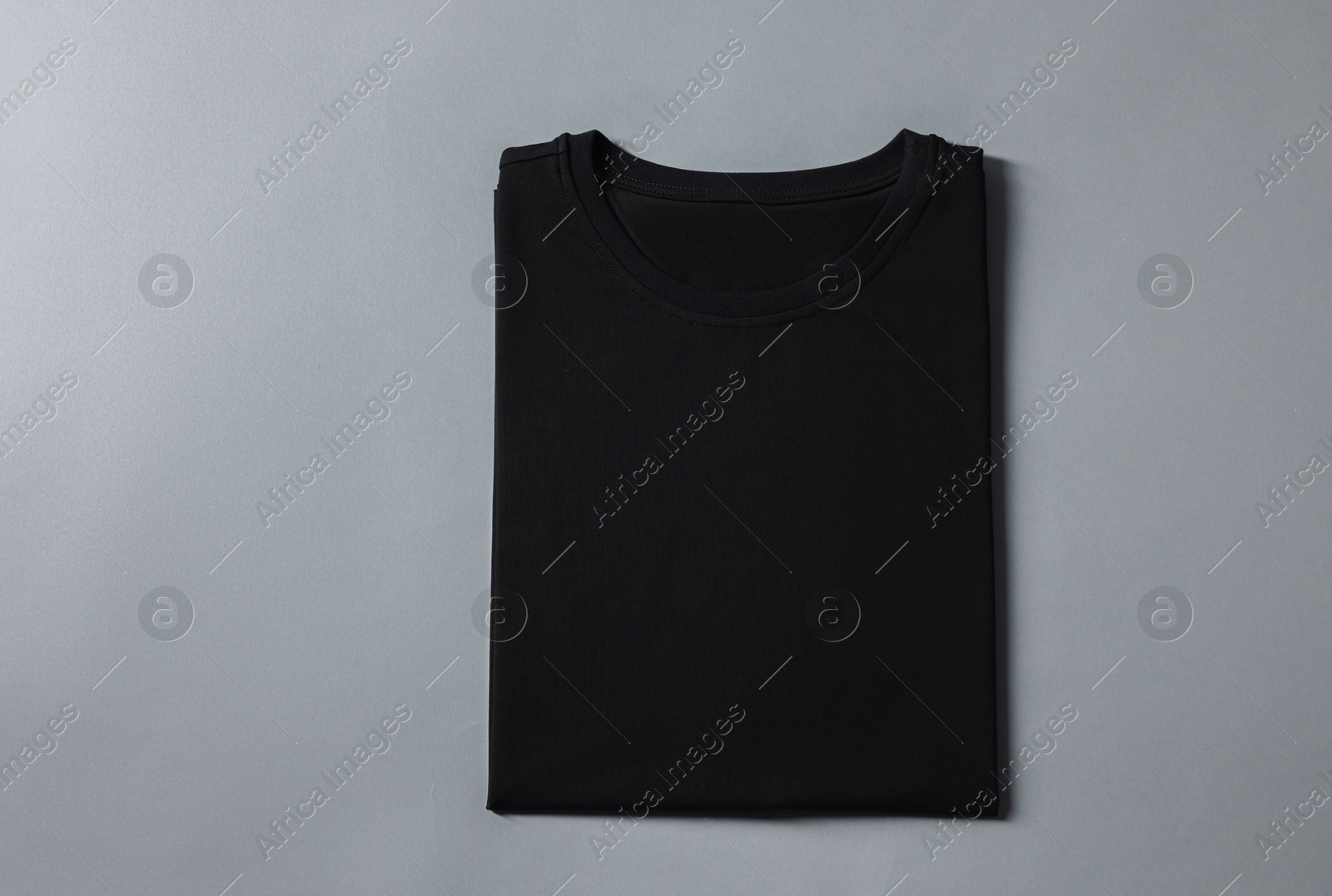 Photo of Blank black t-shirt on grey background, top view. Mockup for design