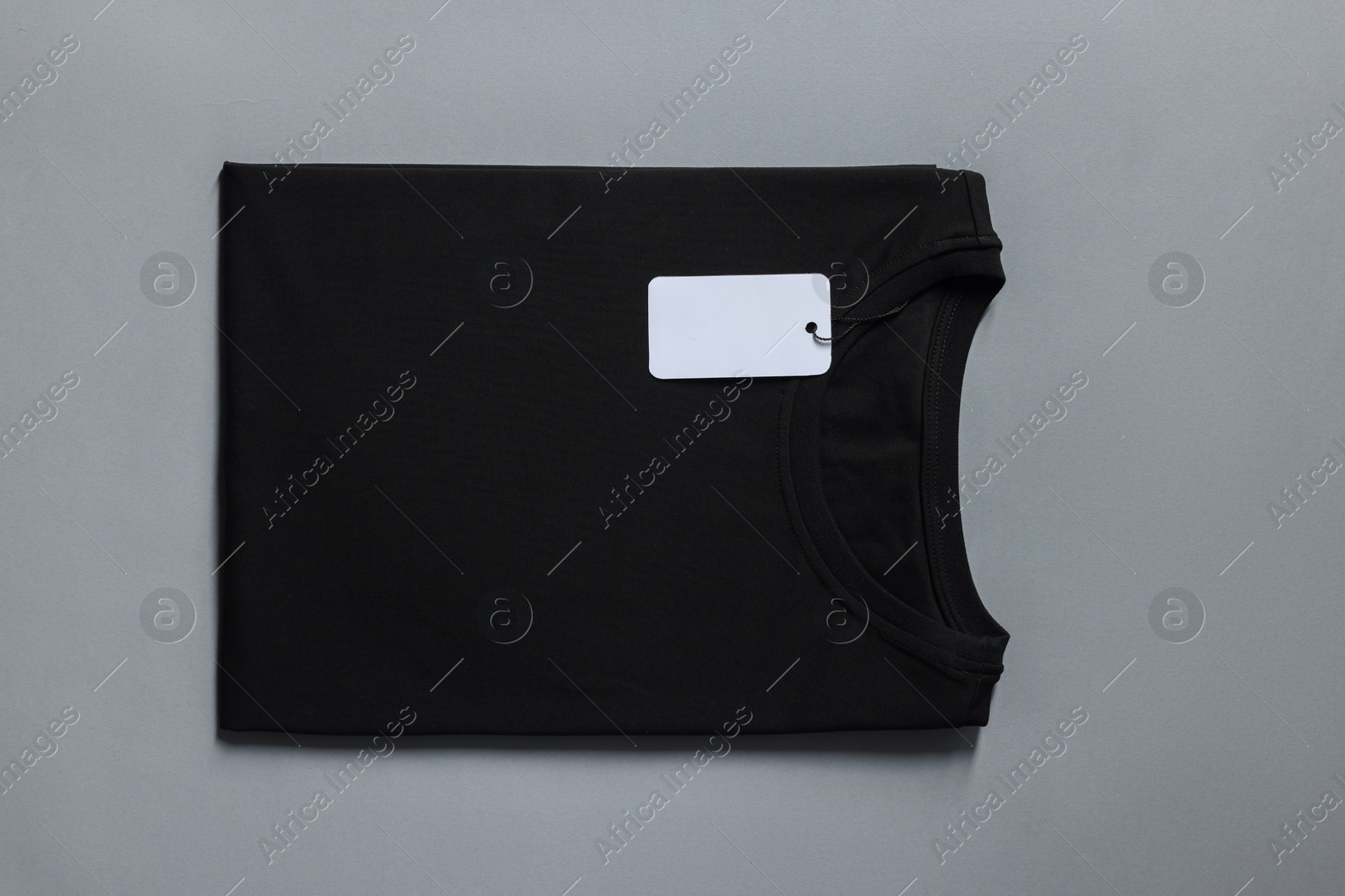 Photo of Blank black t-shirt on grey background, top view. Mockup for design