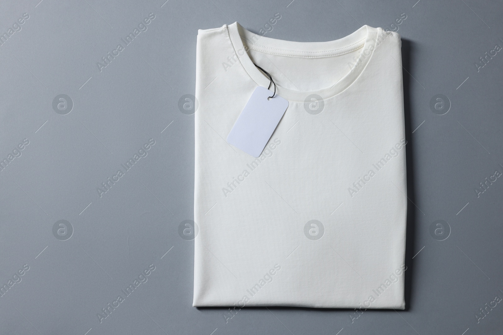 Photo of Blank white t-shirt on grey background, top view. Mockup for design