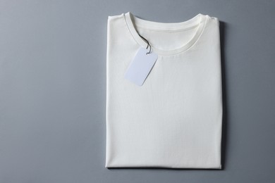 Photo of Blank white t-shirt on grey background, top view. Mockup for design