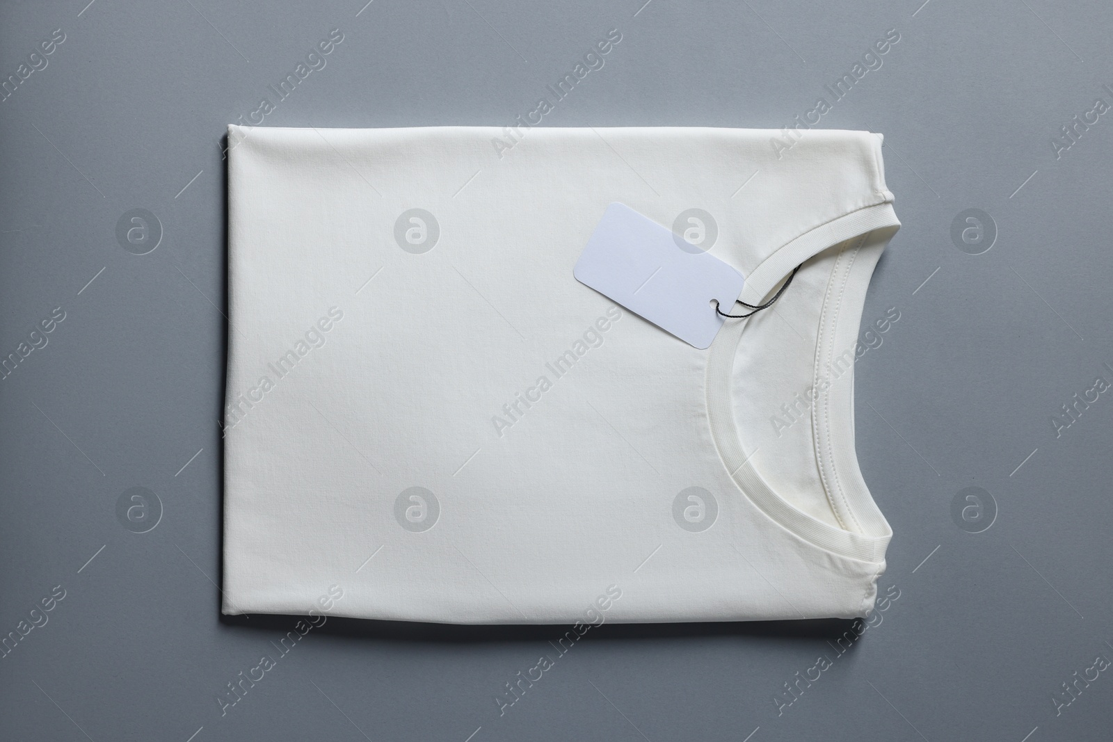 Photo of Blank white t-shirt on grey background, top view. Mockup for design