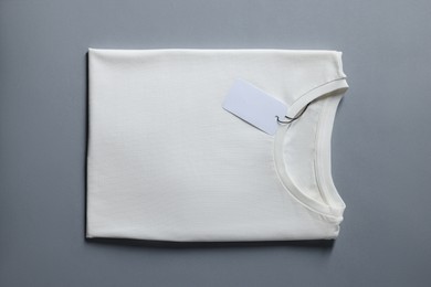 Photo of Blank white t-shirt on grey background, top view. Mockup for design