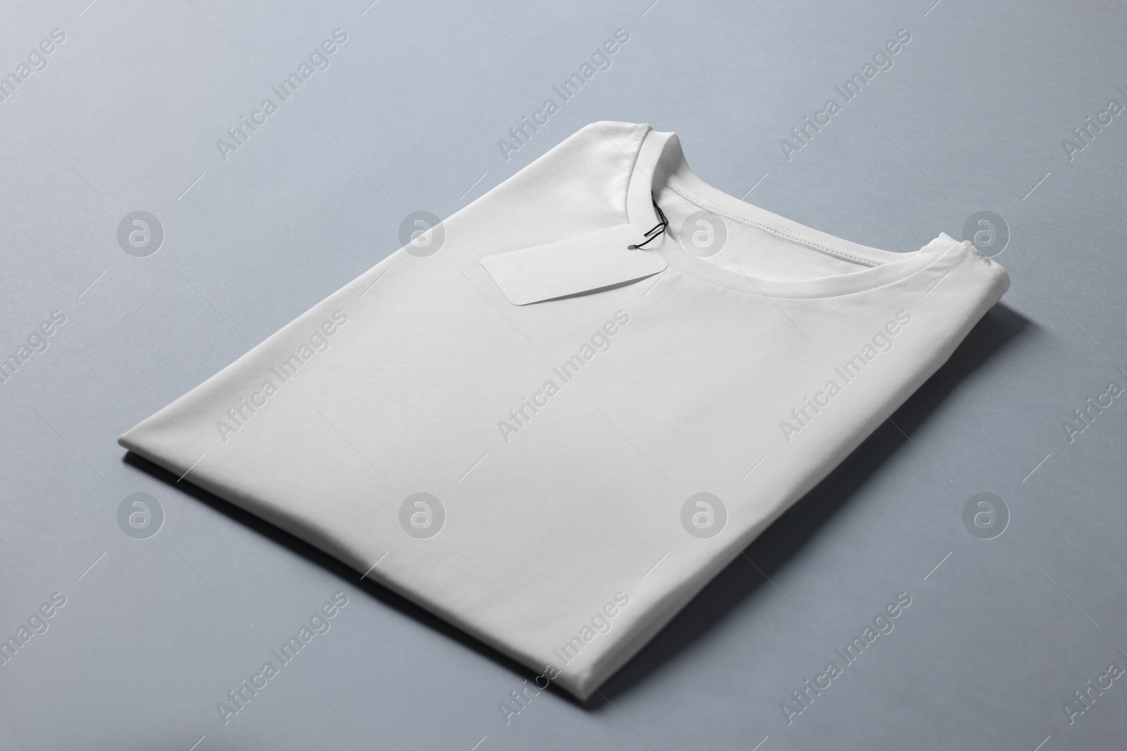 Photo of Blank white t-shirt on grey background. Mockup for design