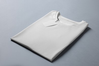 Photo of Blank white t-shirt on grey background. Mockup for design