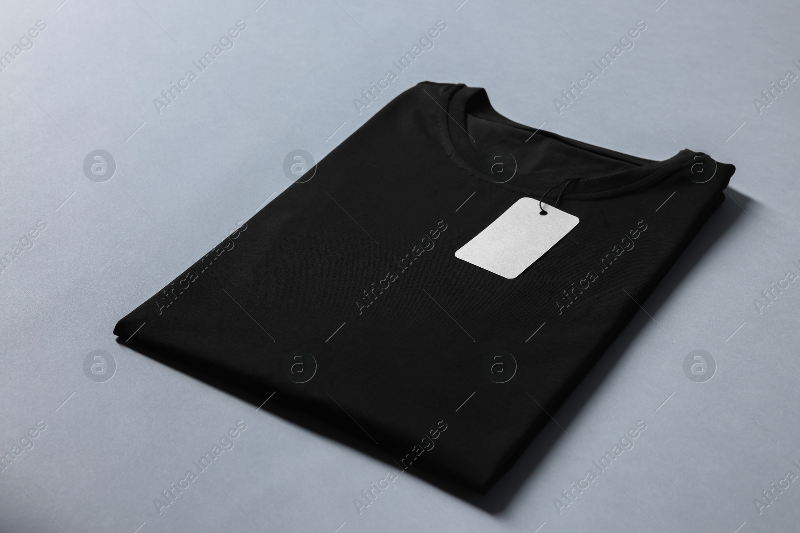 Photo of Blank black t-shirt on grey background. Mockup for design