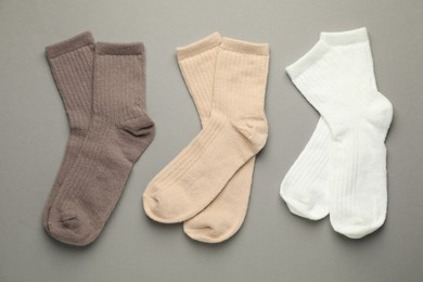 Photo of Different soft socks on light grey background, flat lay