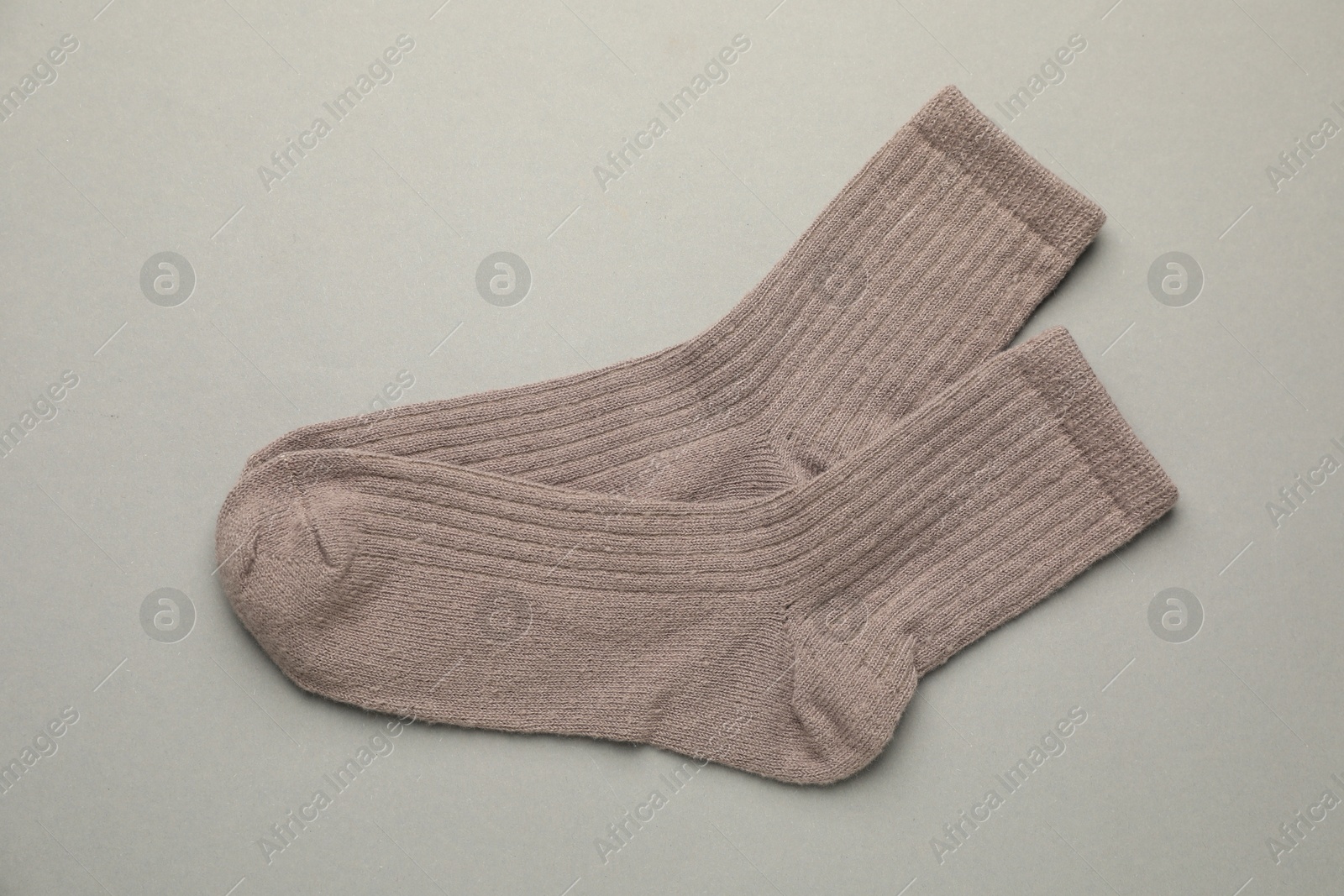 Photo of Pair of soft socks on light grey background, top view