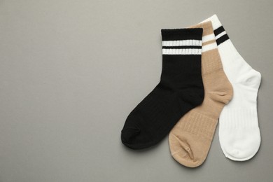 Photo of Different soft socks on light grey background, flat lay. Space for text