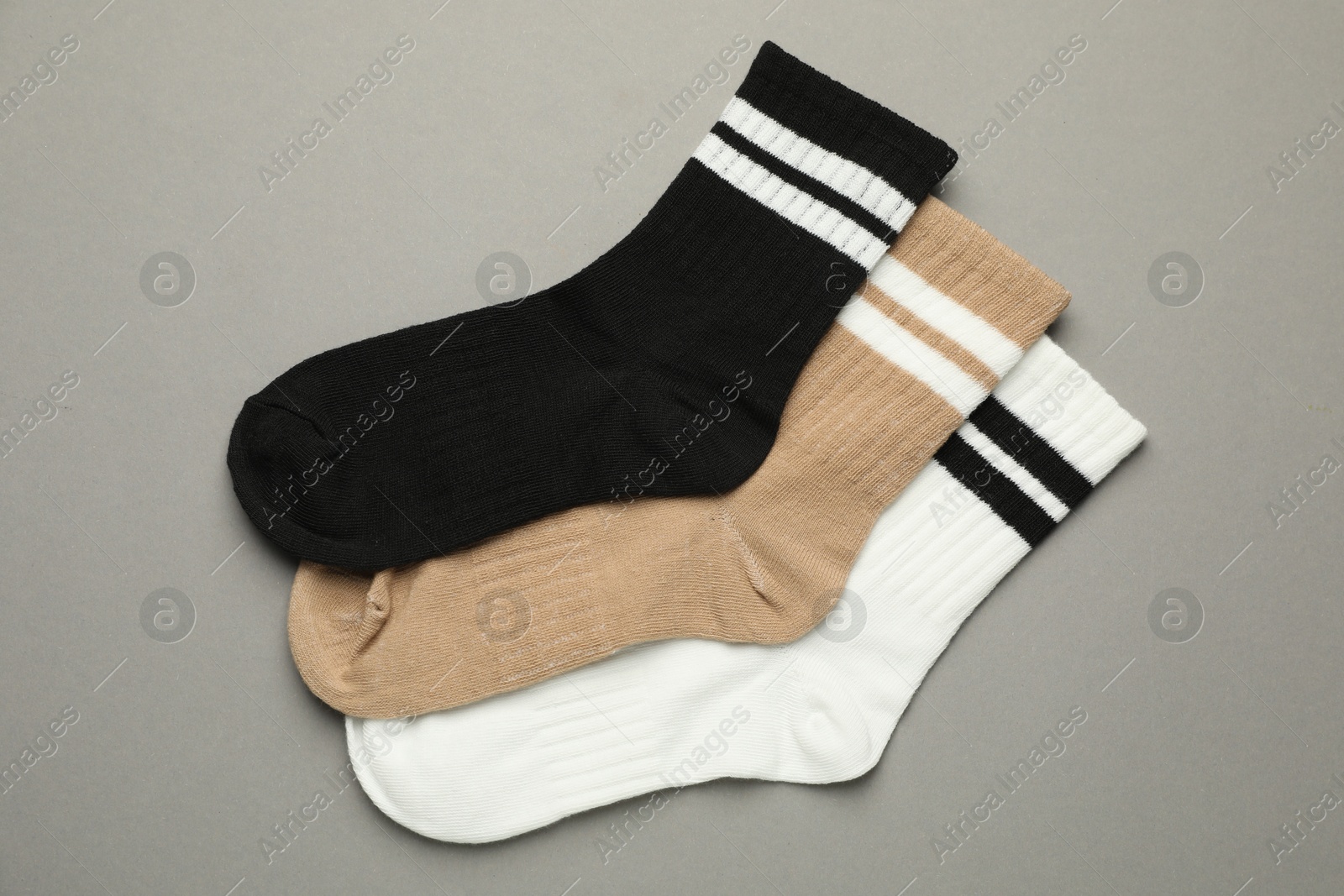 Photo of Different soft socks on light grey background, flat lay