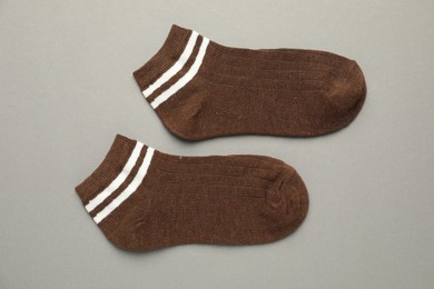 Photo of Pair of soft socks on light grey background, top view