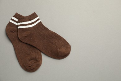 Photo of Pair of soft socks on light grey background, top view. Space for text