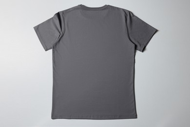 One blank t-shirt on white background, top view. Mockup for design