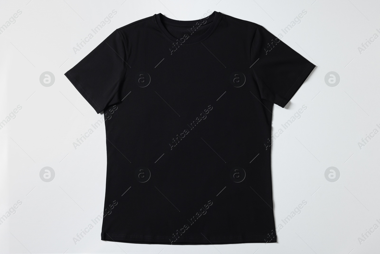 Photo of One blank t-shirt on white background, top view. Mockup for design