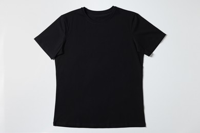 Photo of One blank t-shirt on white background, top view. Mockup for design