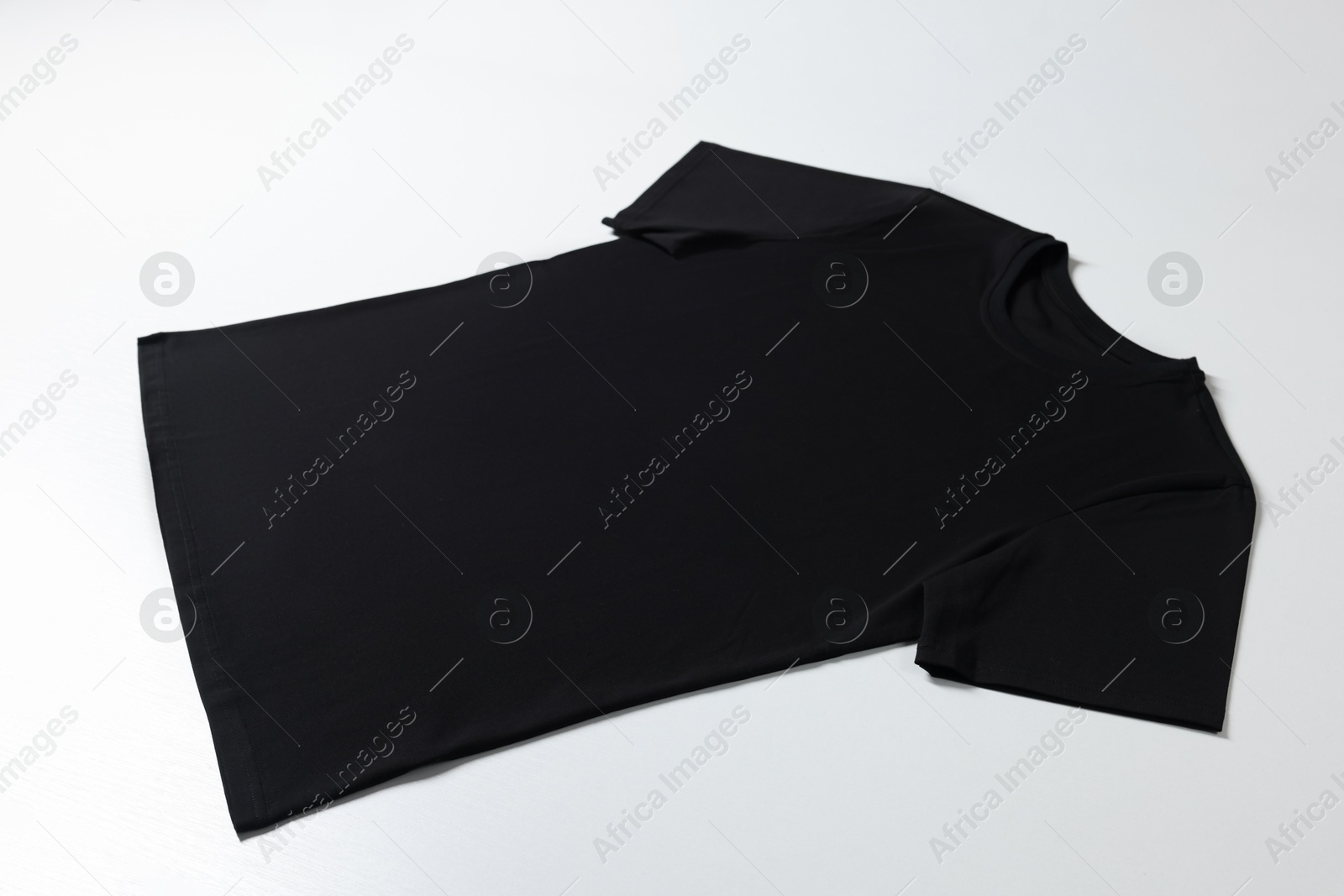 Photo of One blank t-shirt on white background. Mockup for design