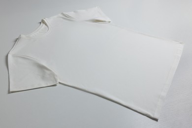 Photo of One blank t-shirt on white background. Mockup for design