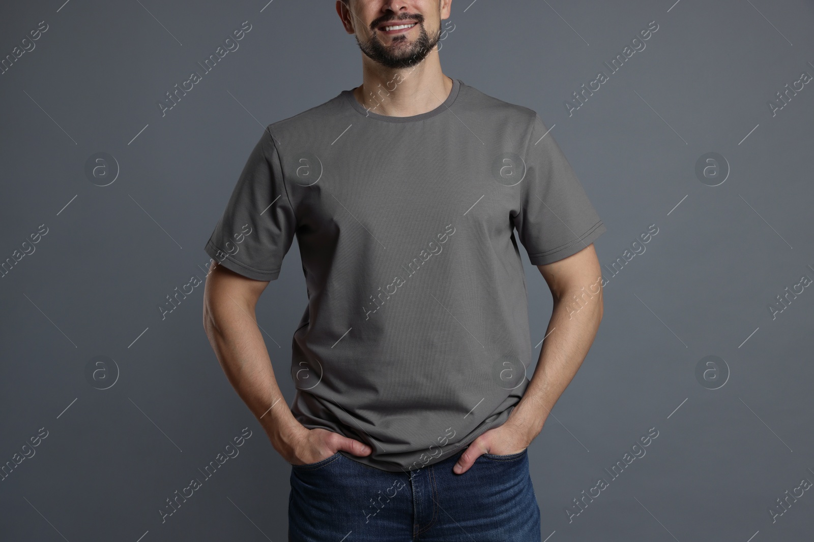 Photo of Man in blank t-shirt on grey background, closeup. Mockup for design