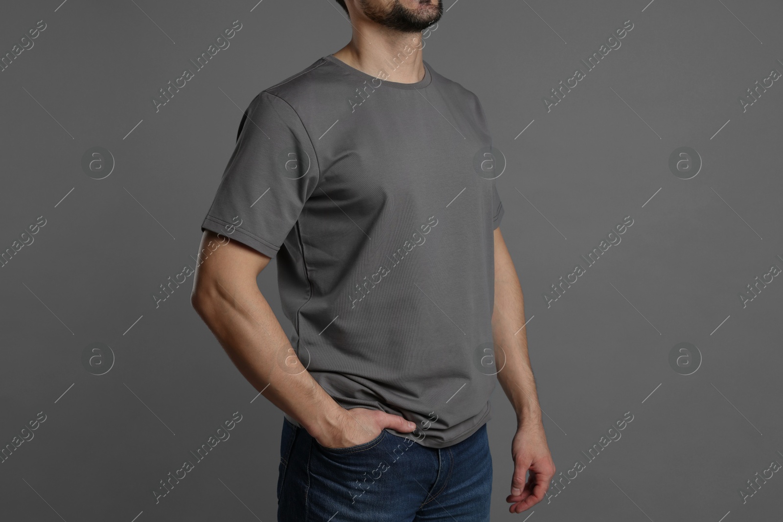 Photo of Man in blank t-shirt on grey background, closeup. Mockup for design