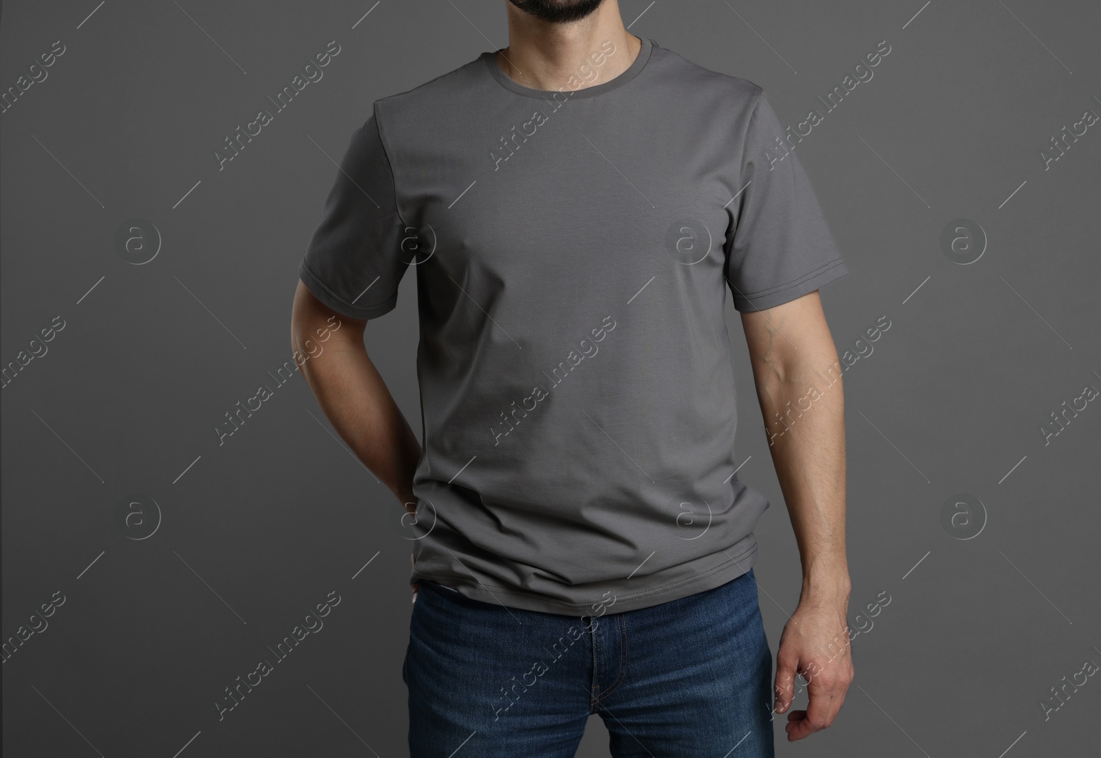 Photo of Man in blank t-shirt on grey background, closeup. Mockup for design