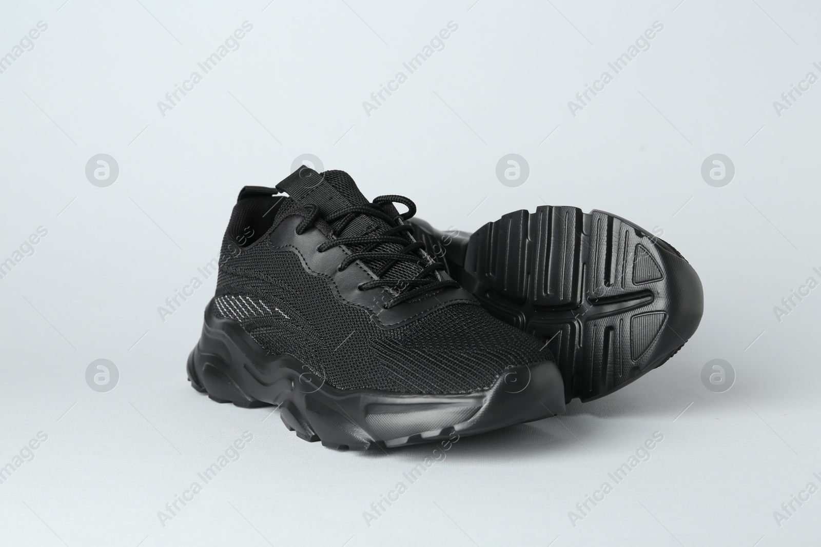 Photo of Pair of stylish black sneakers on white background