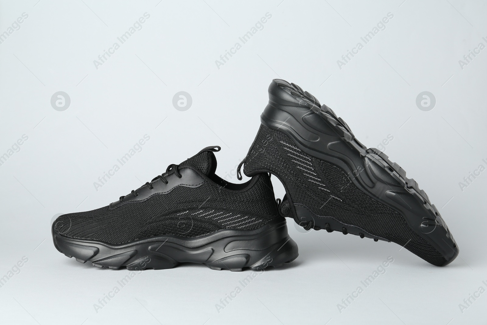 Photo of Pair of stylish black sneakers on white background