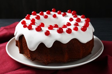 Photo of Tasty Christmas cake with red currants on table, closeup