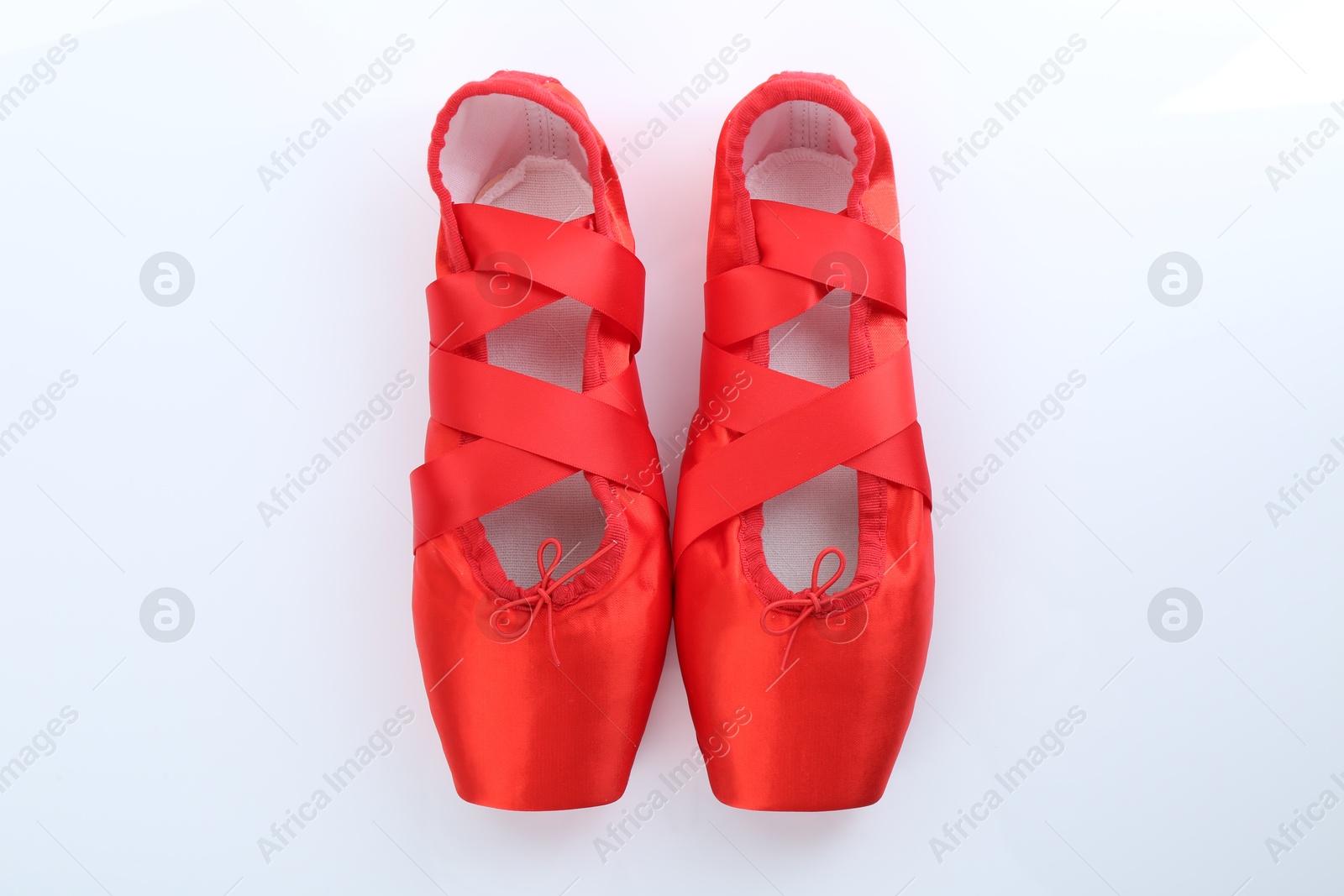 Photo of Pair of beautiful red pointe shoes on white background, top view