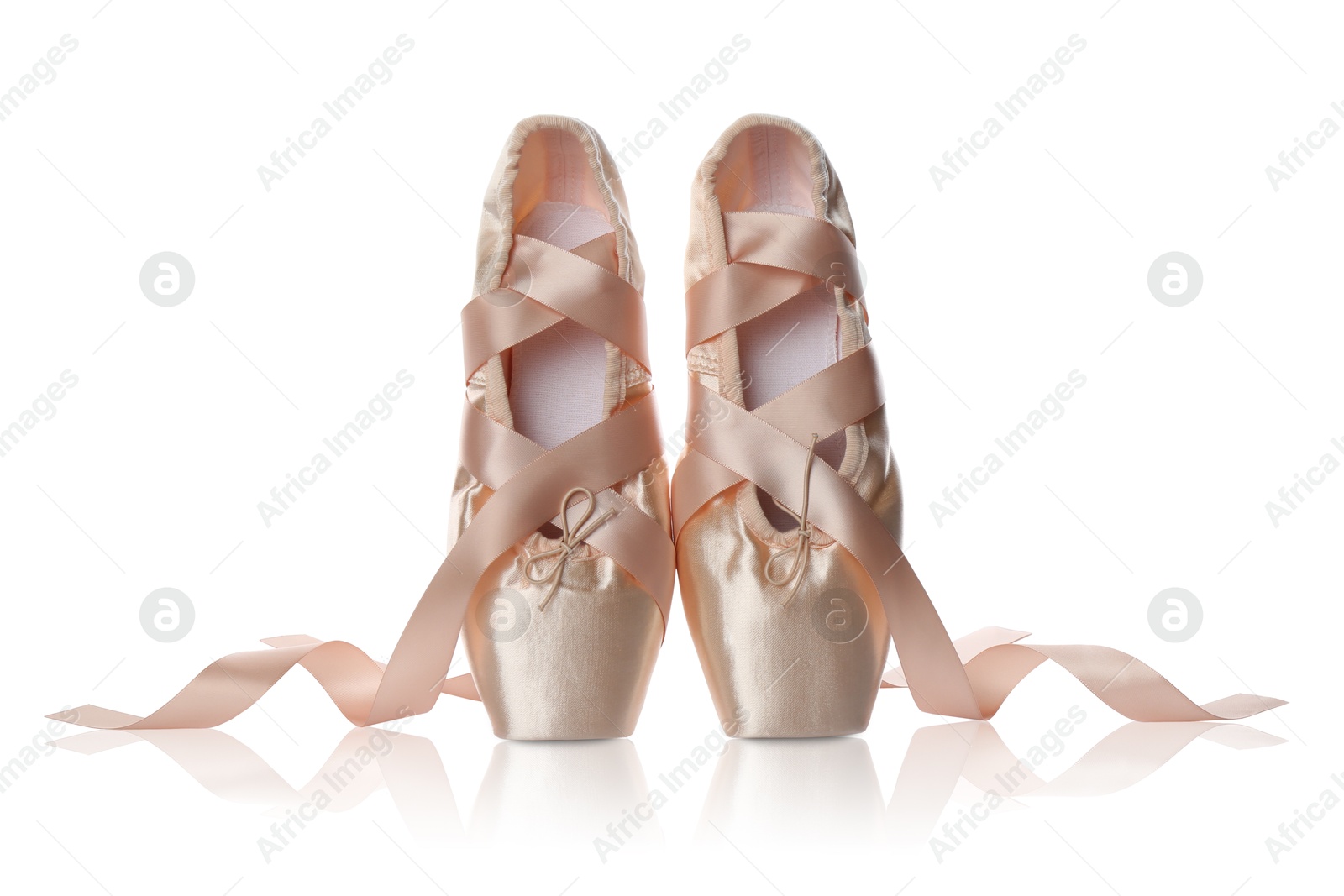 Photo of Pair of beautiful beige pointe shoes isolated on white