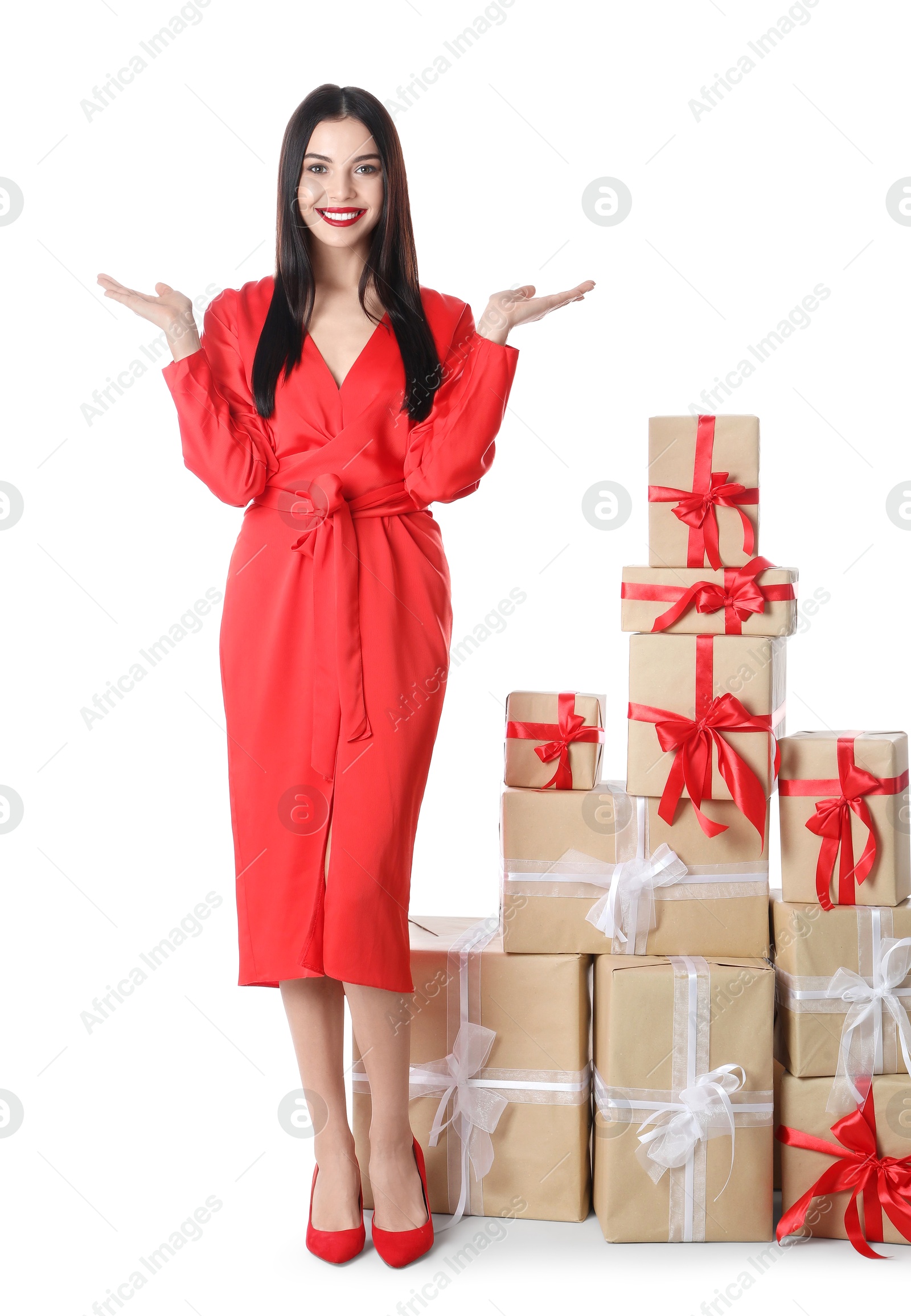 Photo of Woman in red dress with Christmas gifts on white background