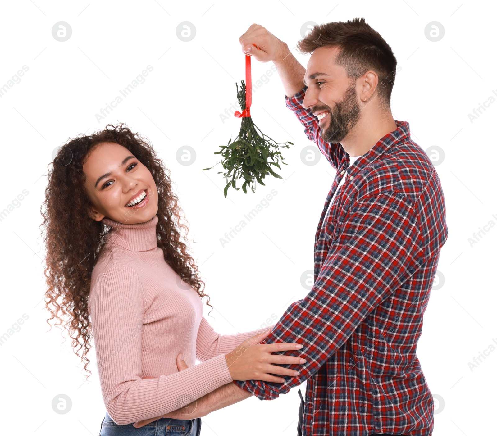 Photo of Lovely couple under mistletoe bunch on white background