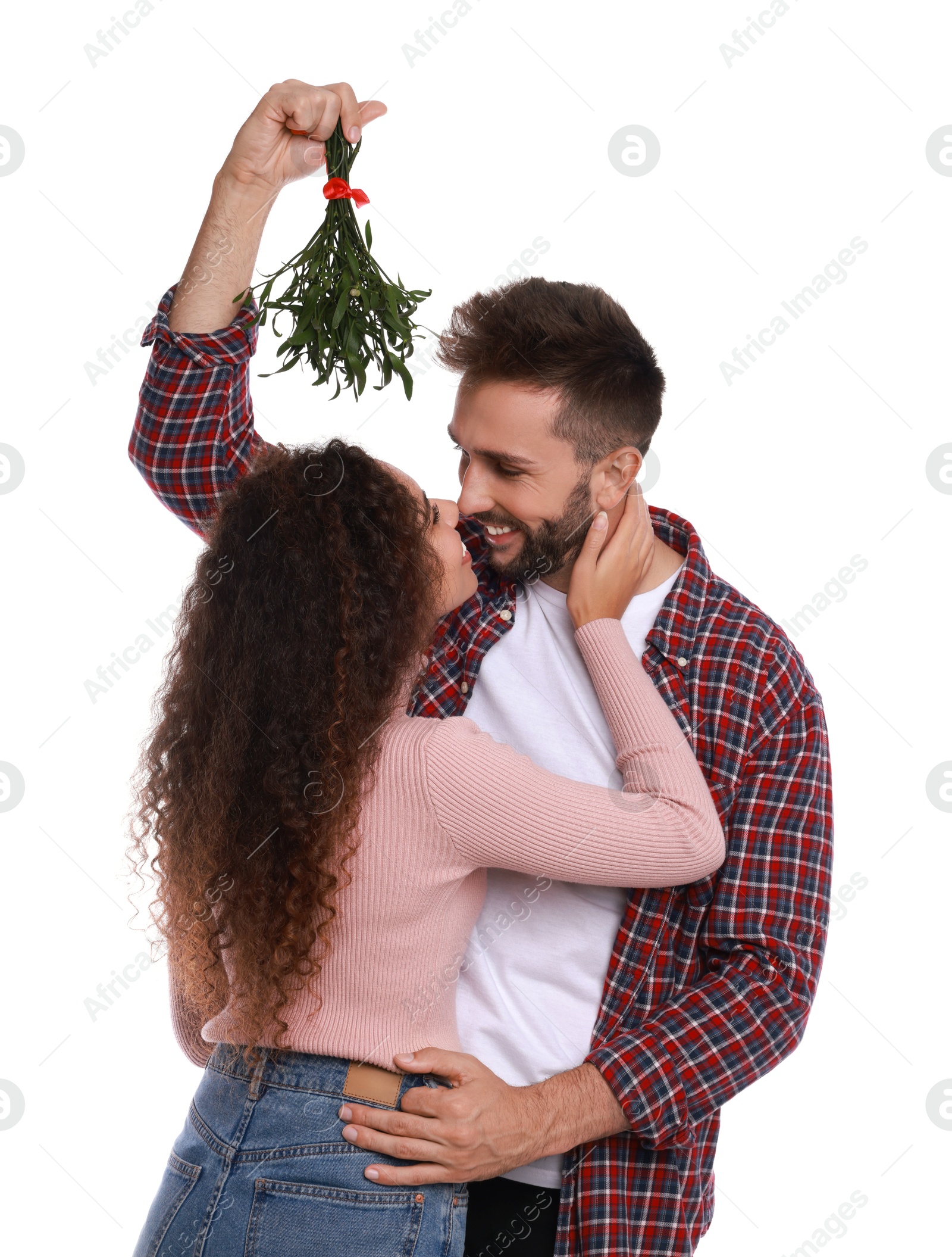 Photo of Lovely couple under mistletoe bunch on white background