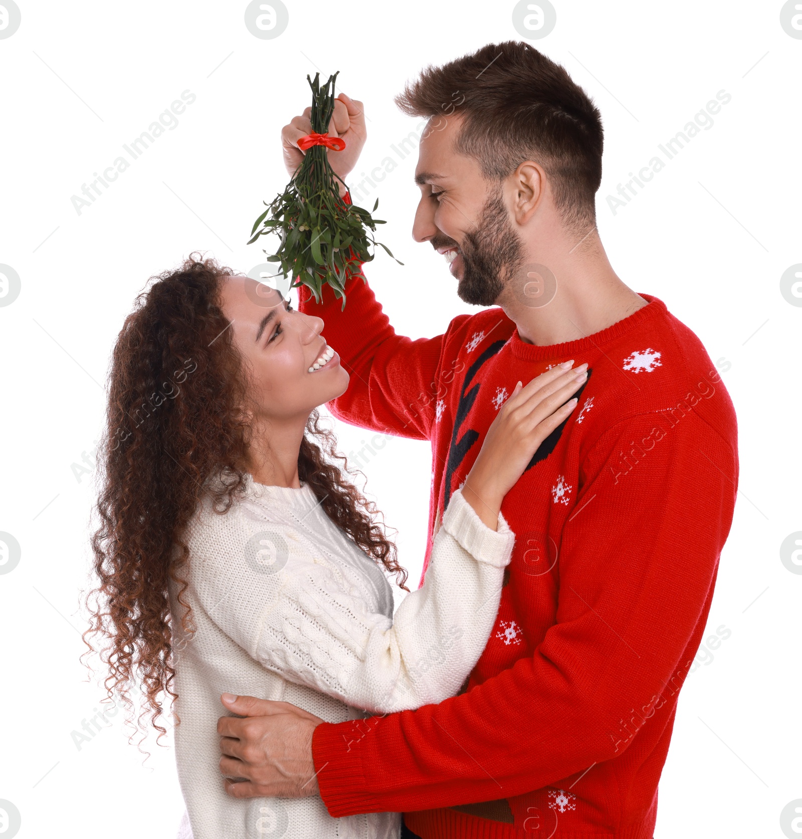 Photo of Lovely couple under mistletoe bunch on white background