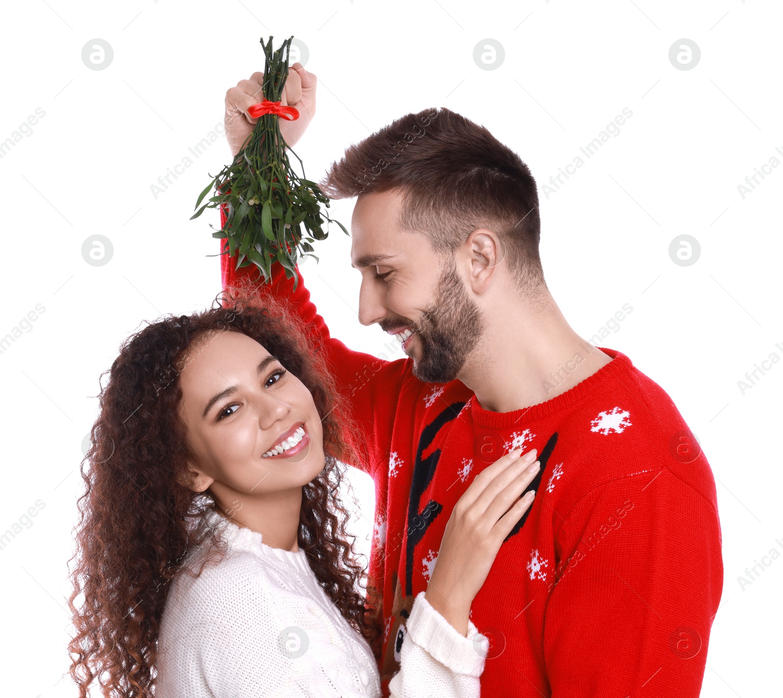 Photo of Lovely couple under mistletoe bunch on white background