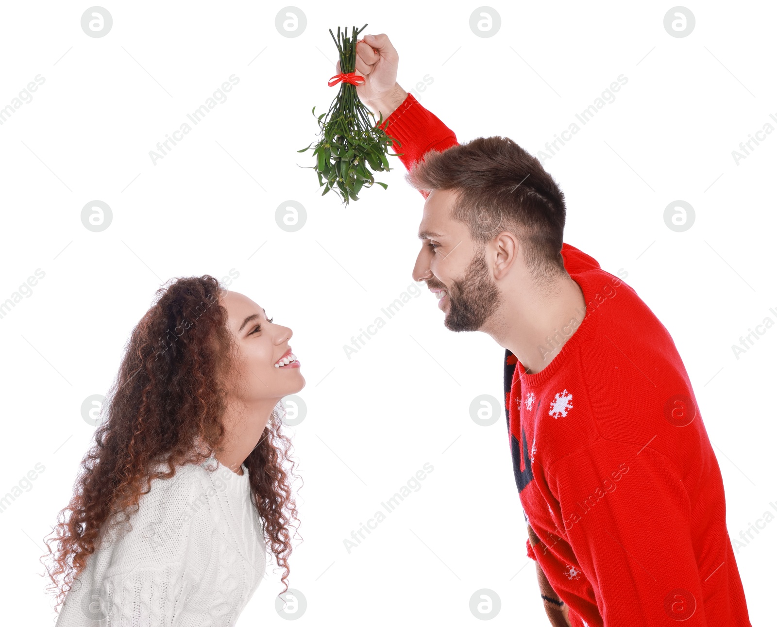 Photo of Lovely couple under mistletoe bunch on white background