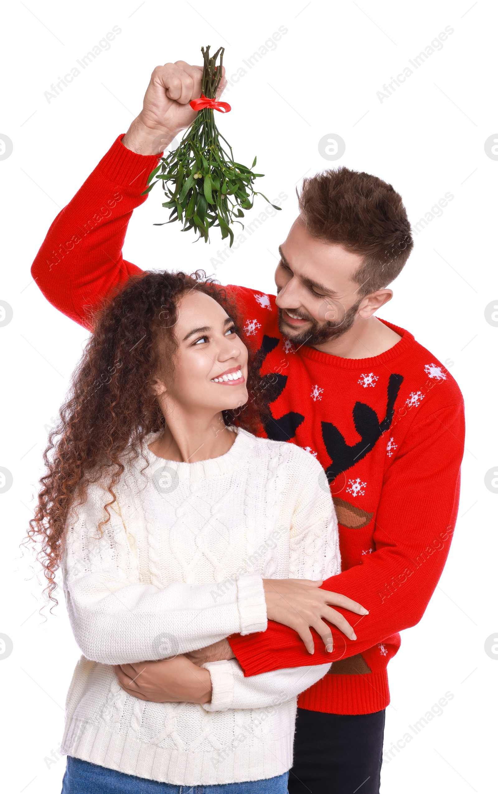 Photo of Lovely couple under mistletoe bunch on white background