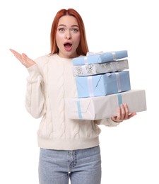 Photo of Emotional young woman in sweater with Christmas gifts on white background