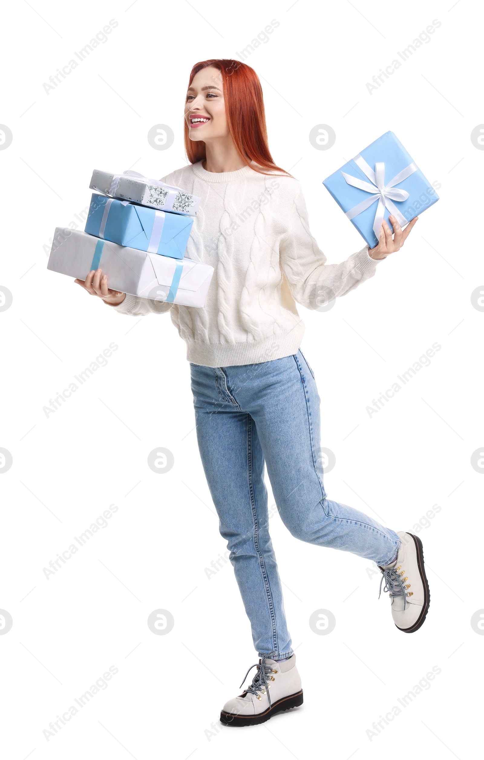 Photo of Young woman in sweater with Christmas gifts on white background